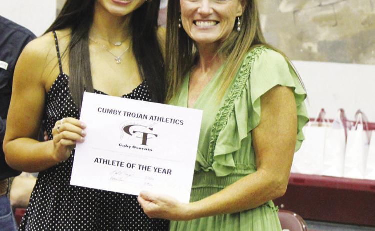 Gaby Osornio (left) was named Female Athlete of the Year at the Cumby Collegiate Athletic Banquet Tuesday. Coach Katie Emeyabbi presented the award. Osornio also earned the Spirit MVP Award in cheerleading, Girls Basketball MVP Award and Runner MVP in track and field.